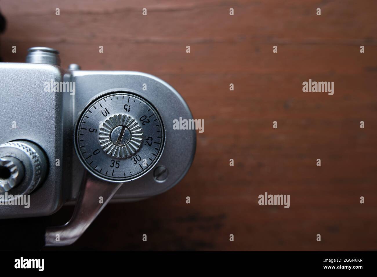 Old vintage 35 mm metal film camera, close-up. The wheel of rewinding frames in close-up. Space for the text. Stock Photo