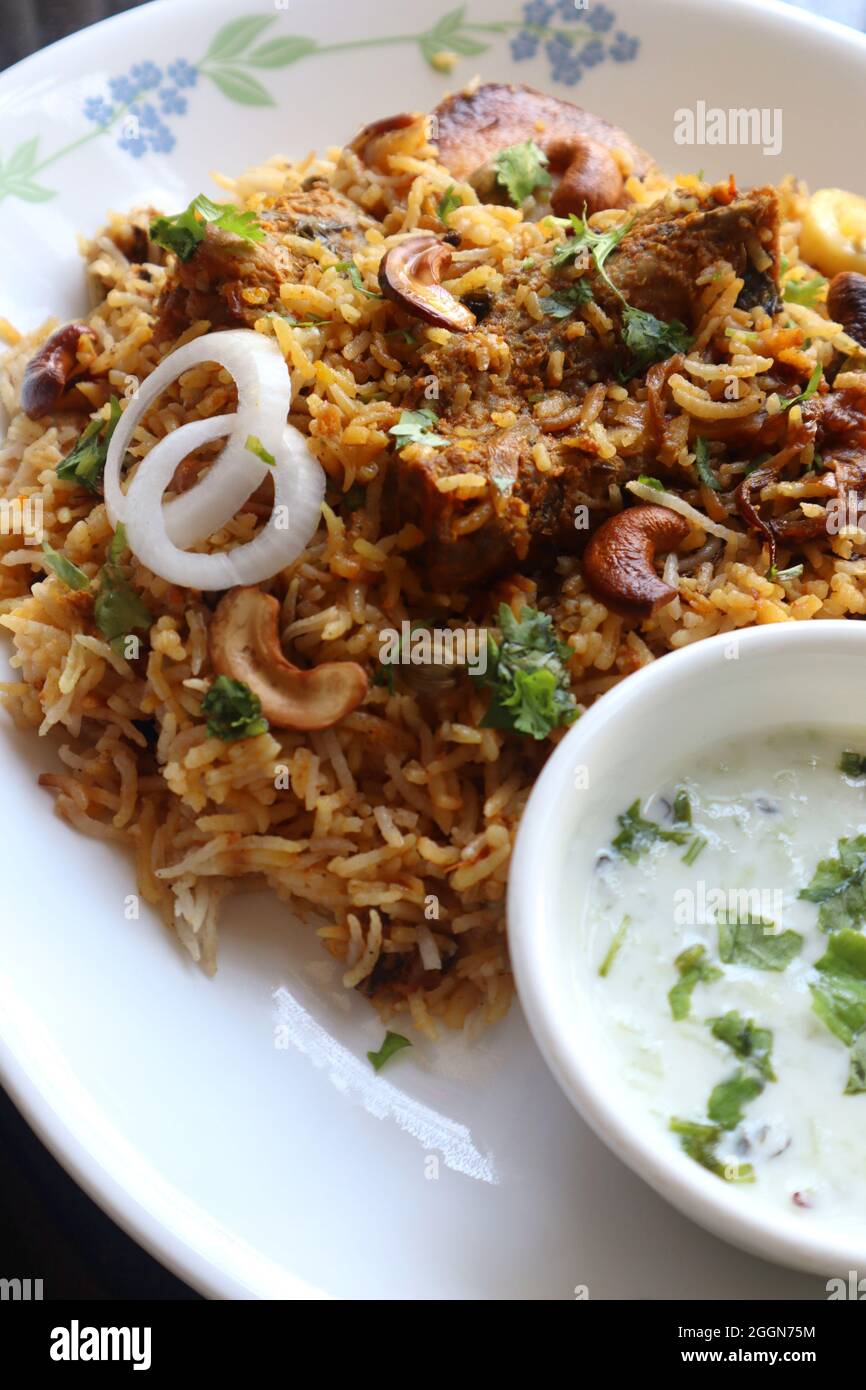 Chicken Biryani or murgh Pulao. Garnished with fried onion, cashews, and coriander. Biryani is a famous Spicy nonvegetarian dish of India. Stock Photo