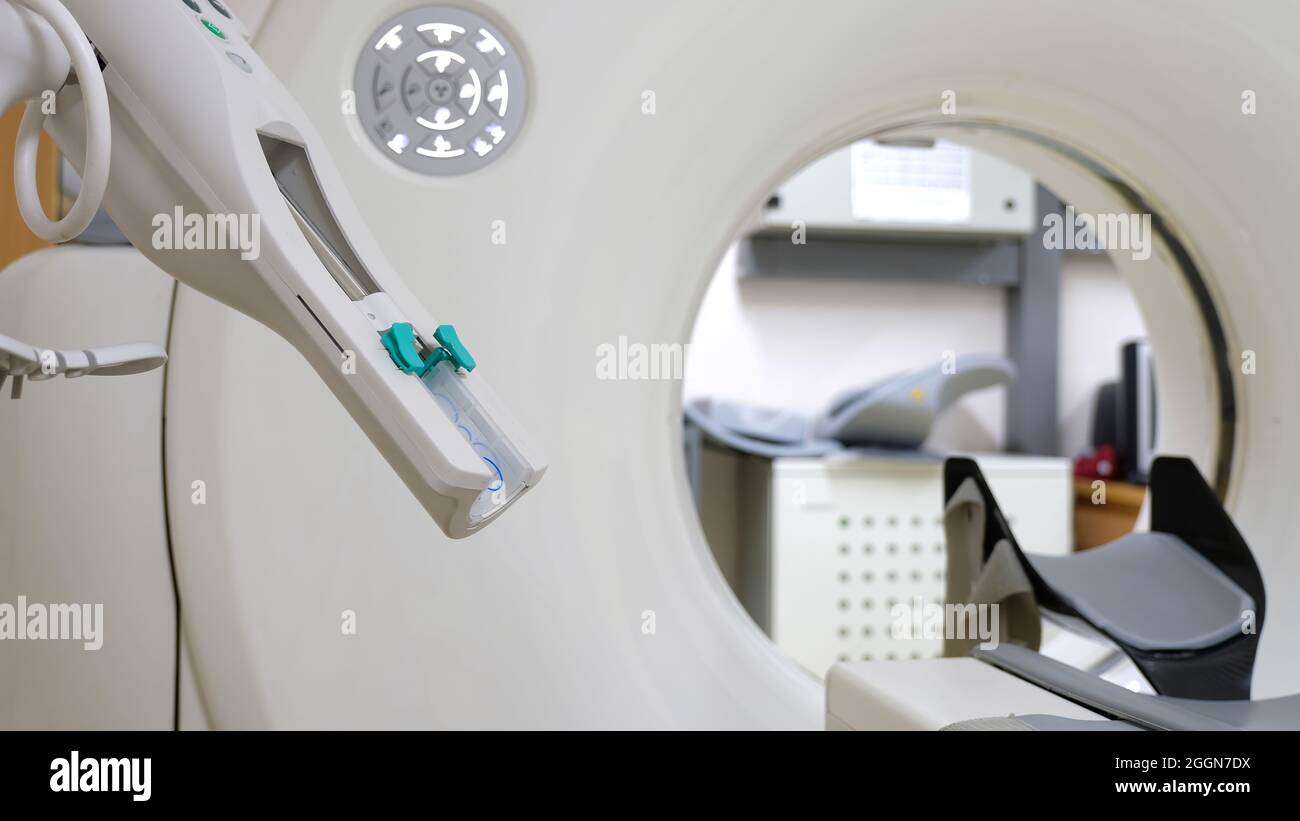 A computer tomography scanner and a contrast media injector. A radio opaque media is used for diagnostic examination in certain circumstances. Stock Photo