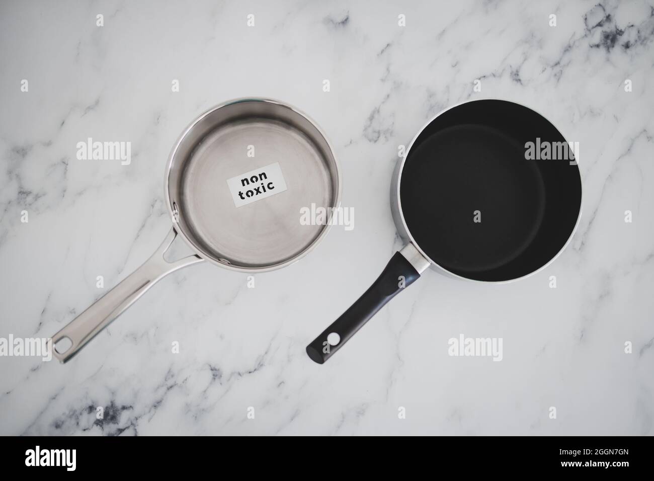 healthy cooking and harsh chemicals concept, stainless steel vs non stick saucepan side by side