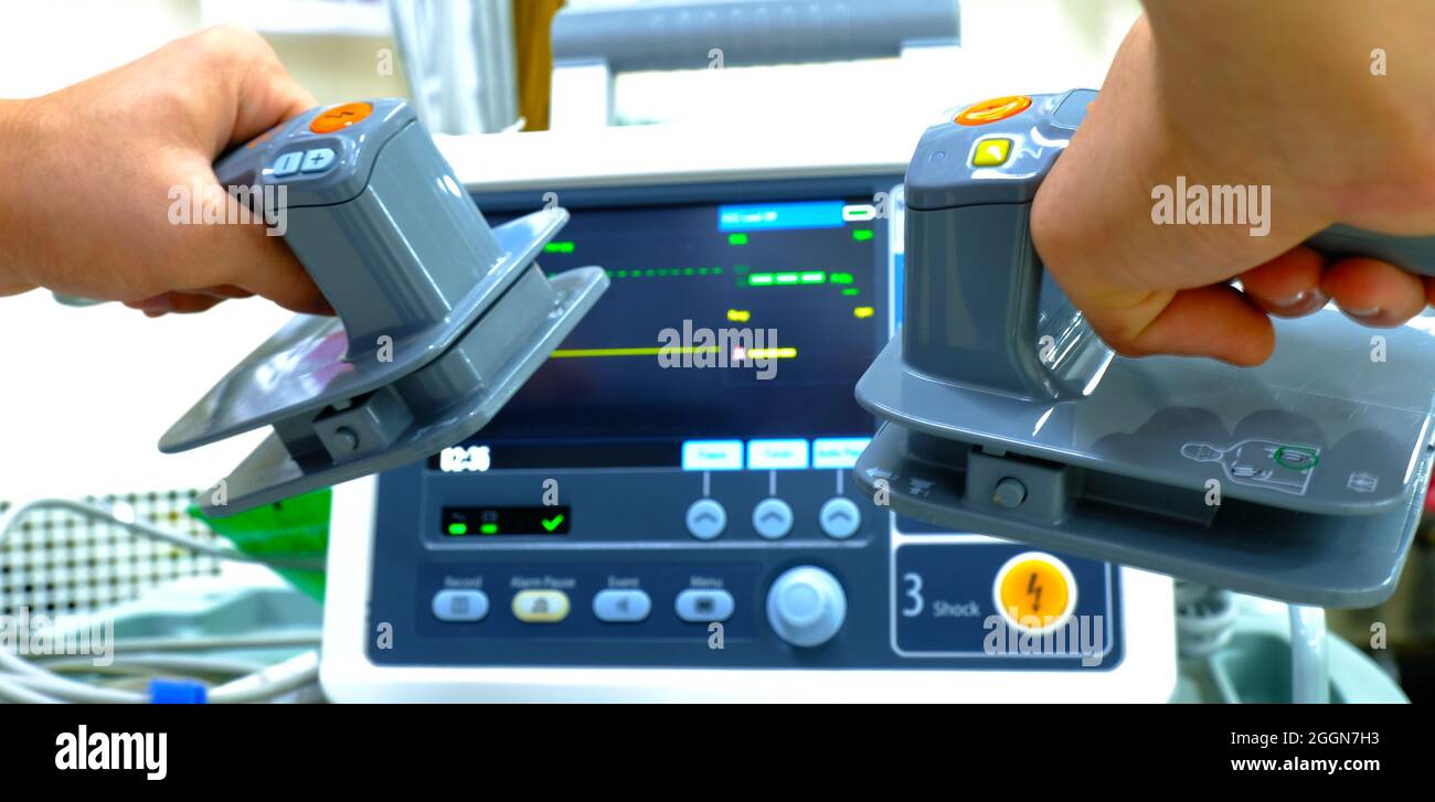 A doctor using a defibrillator in an emergency room Stock Photo Alamy