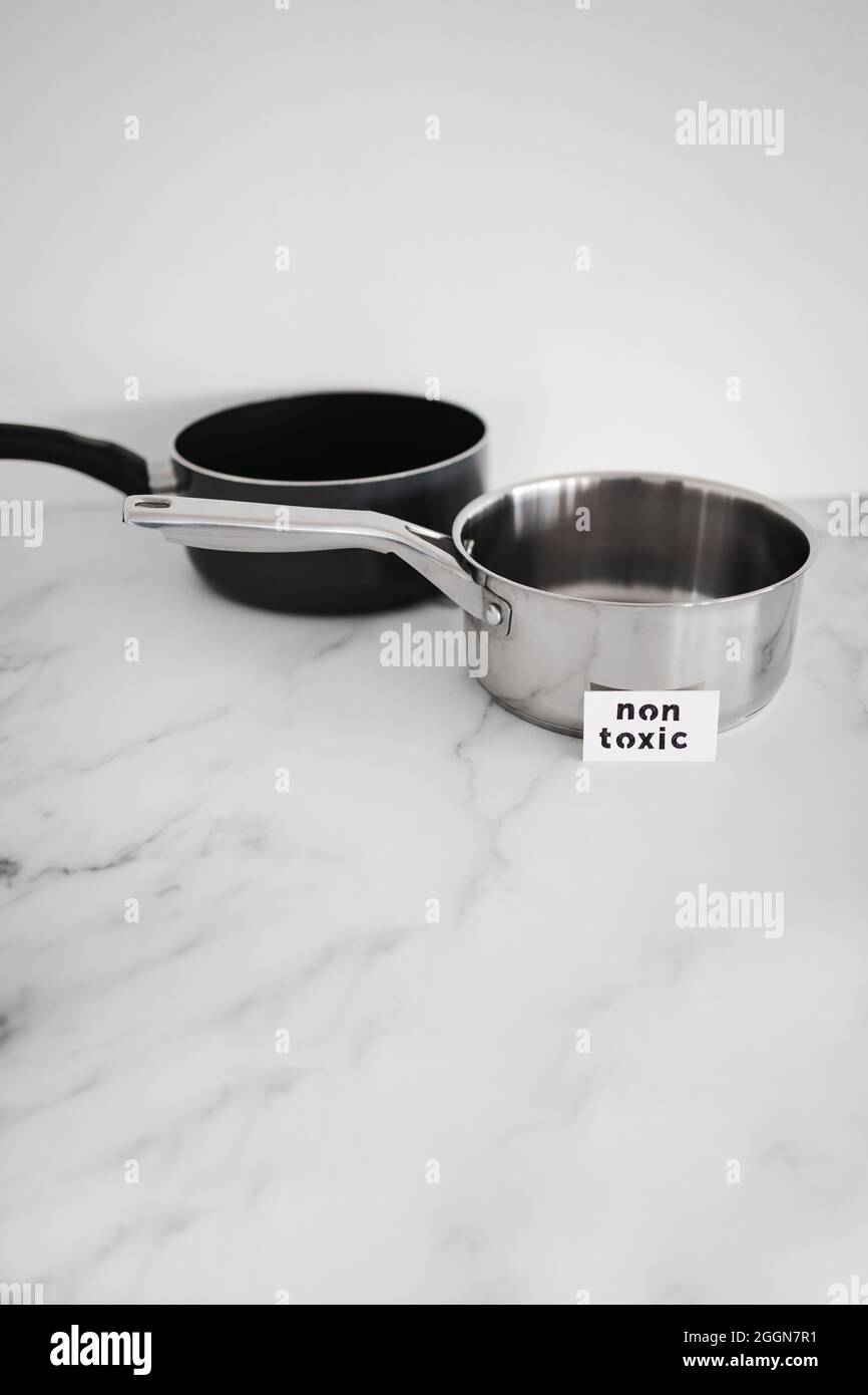 healthy cooking and harsh chemicals concept, stainless steel vs non