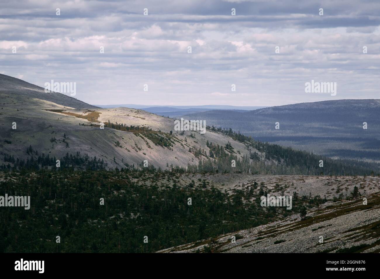 Peaceful landscape in the mountains of Lapland, with patches of sunlight on a fell and clouds in the sky. Stock Photo