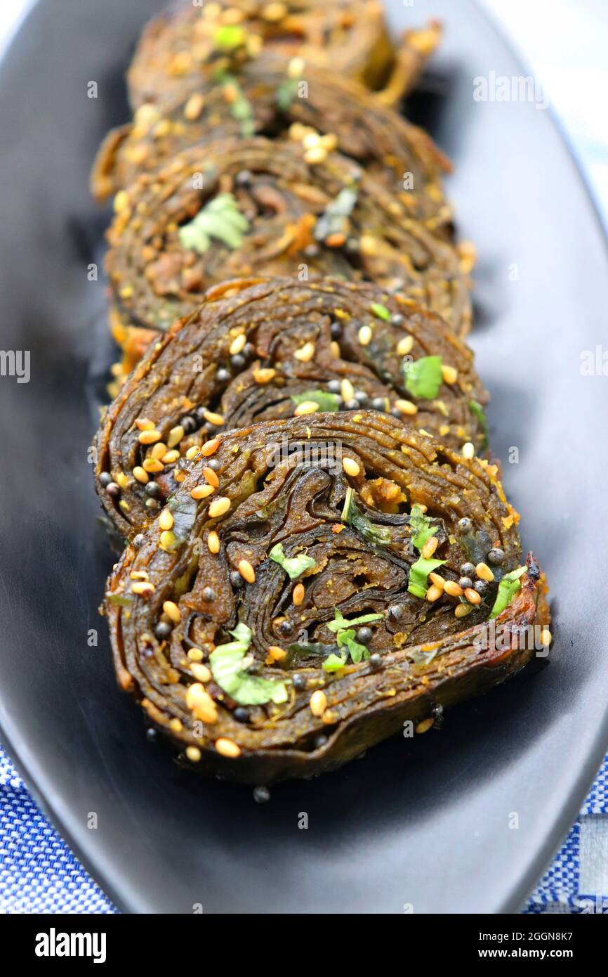 Alu Vadi, Patra, paatra, colocasia leaves roll, Patrode is a popular Indian healthy steamed snack. Garnished with sesame and mustard seeds. copy space Stock Photo