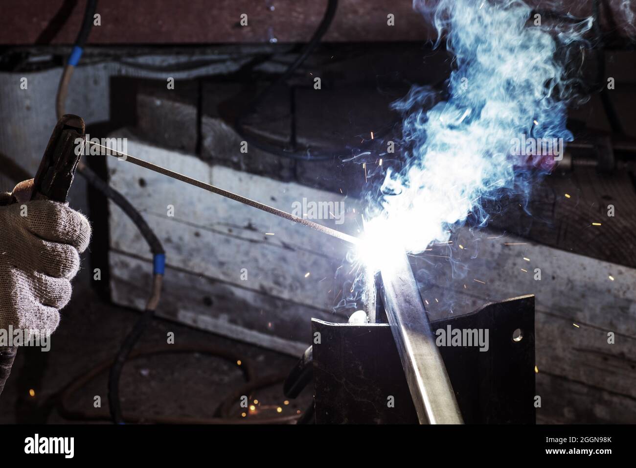The concept of shielded metal arc welding, flame welding, building construction in metal structures, using heat to melt the parts together Stock Photo