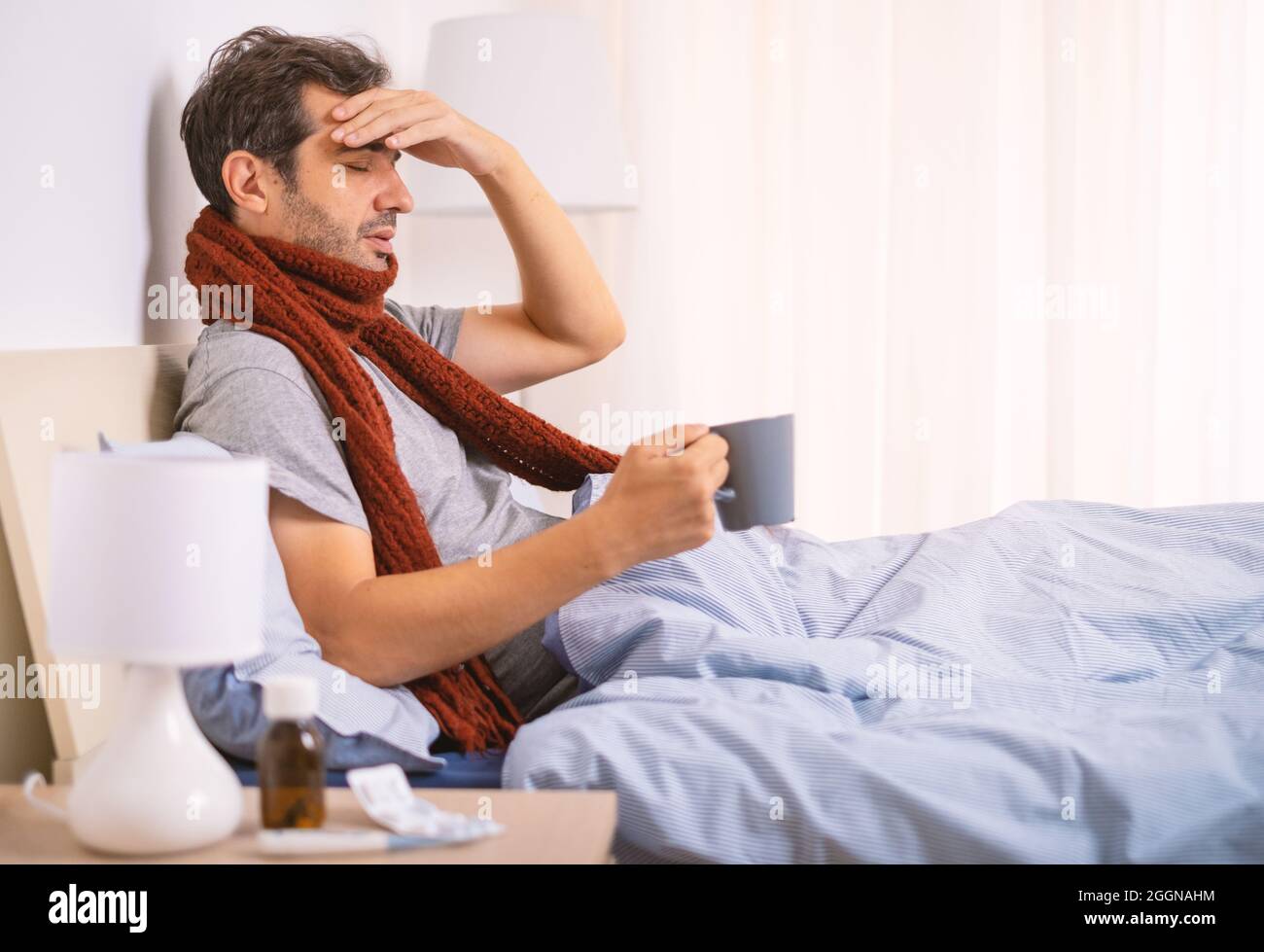 One man feeling fever symptoms and suffering in bed Stock Photo Alamy