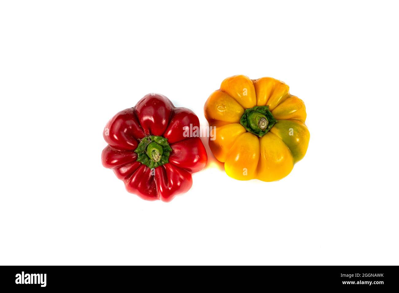 pair of yellow and red peppers on a white background Stock Photo - Alamy