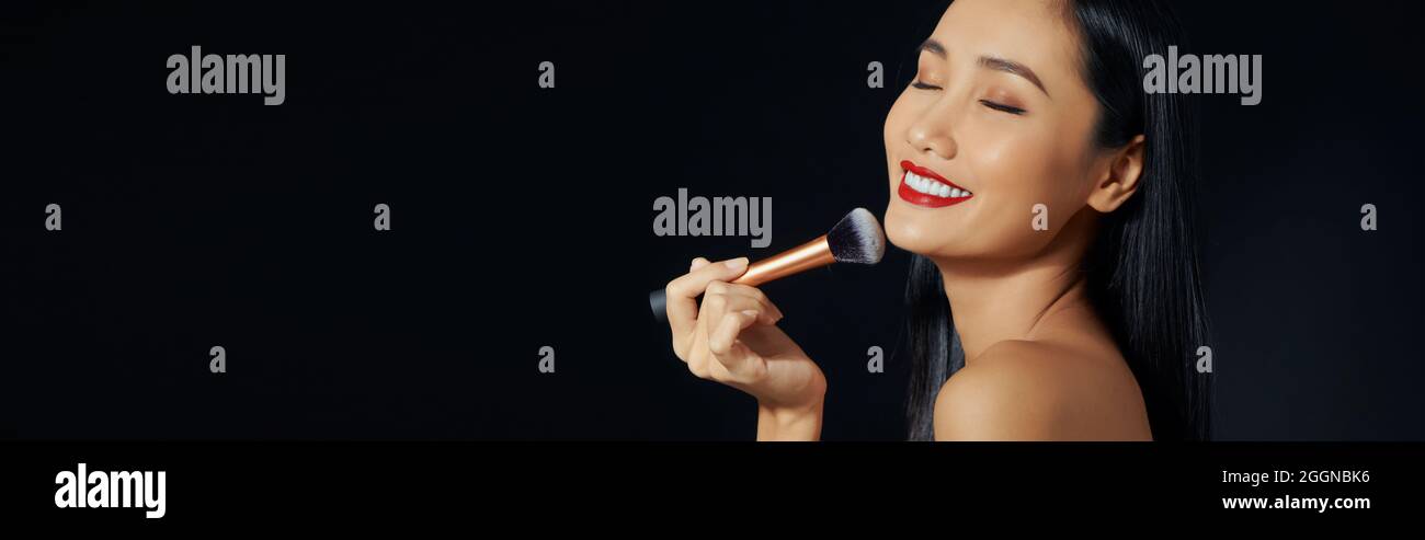 Black woman putting on face hi-res stock photography and images - Alamy