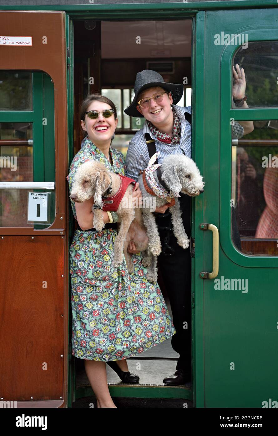 Two females on train in retro attire during a 1950s Weekend event, Watercress Line, Ropley, near Alton, Hampshire, UK. Stock Photo