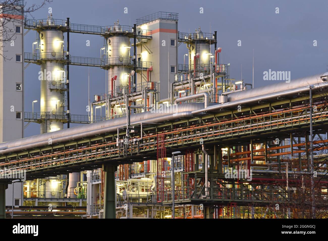 chemical factory at night with buildings, pipelines and lighting - industrial plant Stock Photo