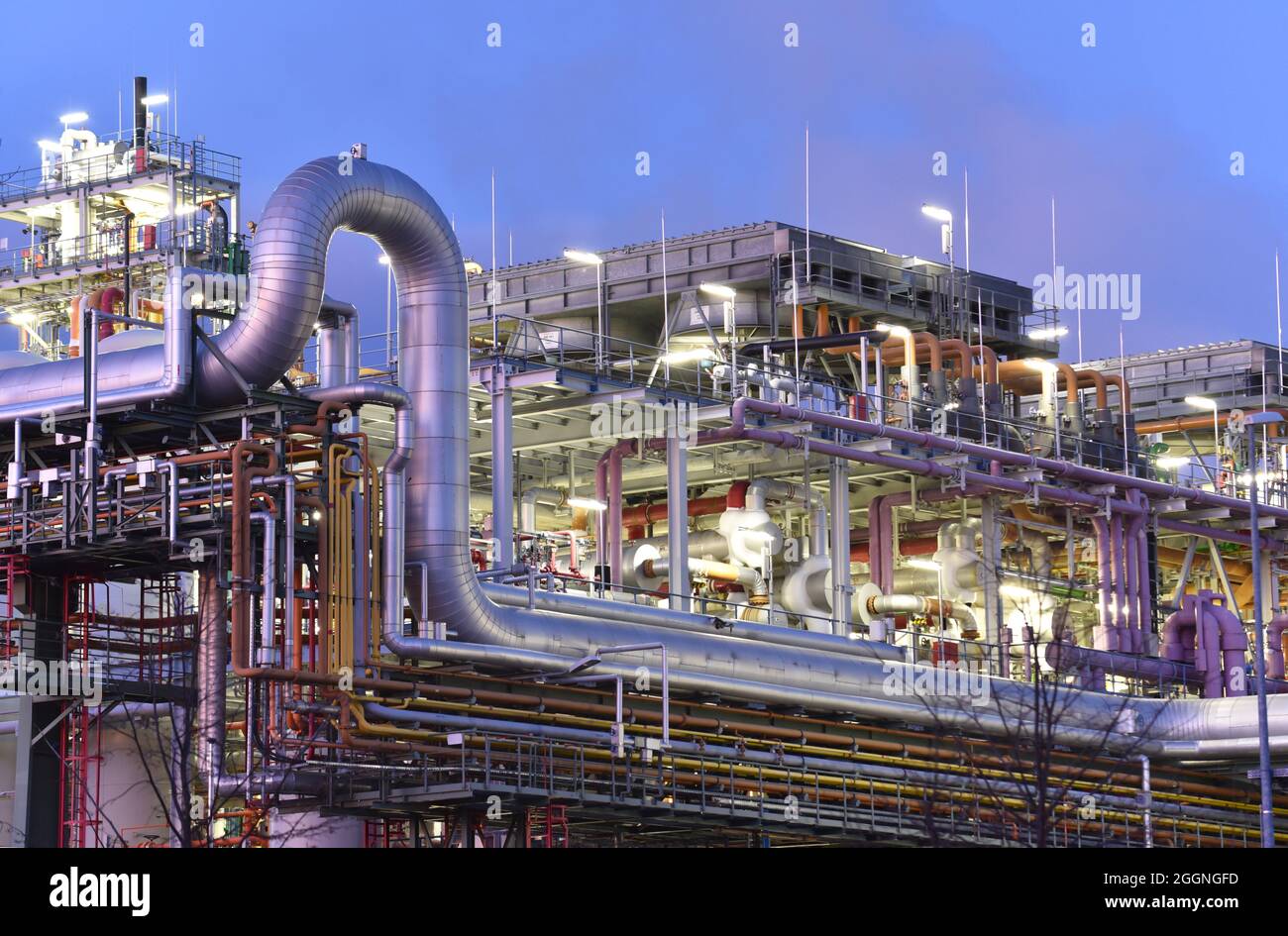 chemical factory at night with buildings, pipelines and lighting - industrial plant Stock Photo