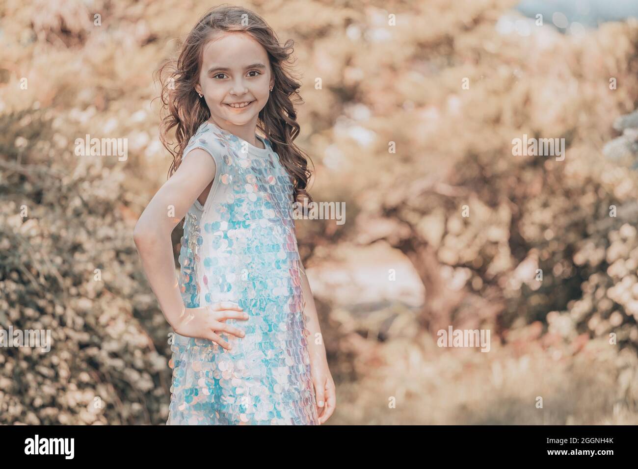 Child Girl Brunette With Dark Hair In A Shiny Dress In Nature Vanilla child-girl-brunette-with-dark-hair-in-a-shiny-dress-in-nature-vanilla