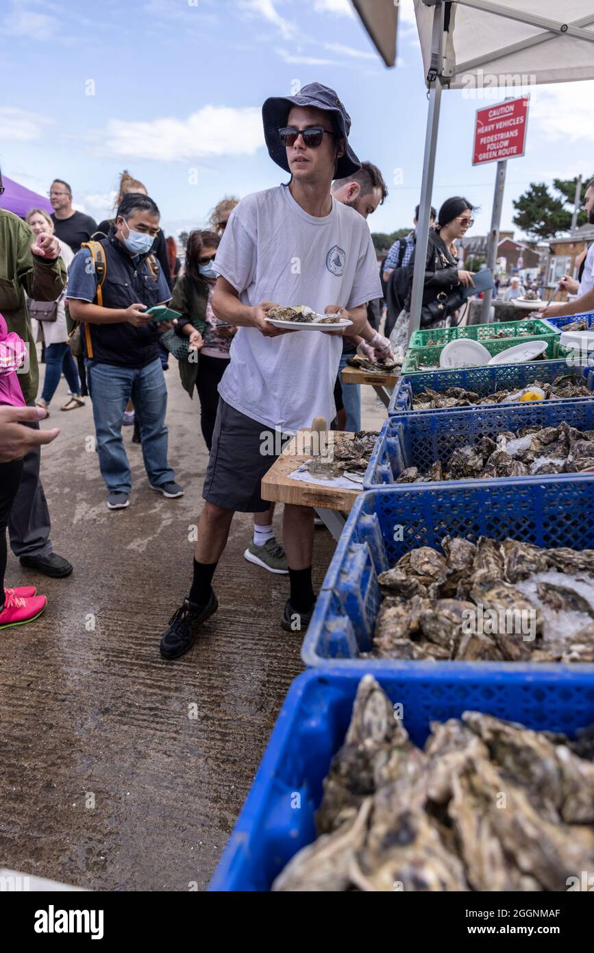 Whitstable seaside town on the north coast of Kent, during the annual Whitstable Oyster Festival, including the traditional 'Landing of the Oysters'. Stock Photo