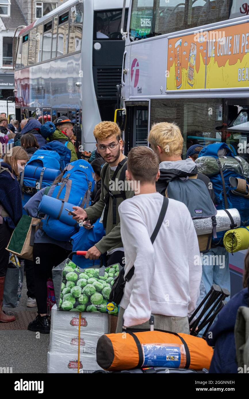Young people queueing for buses to take them to the opening day of The Boardmasters Festival in Cornwall. Stock Photo
