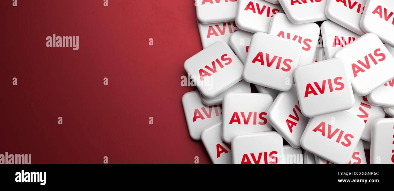 Logos of the rental car company AVIS on a heap on a table. Copy space. Web banner format. Stock Photo