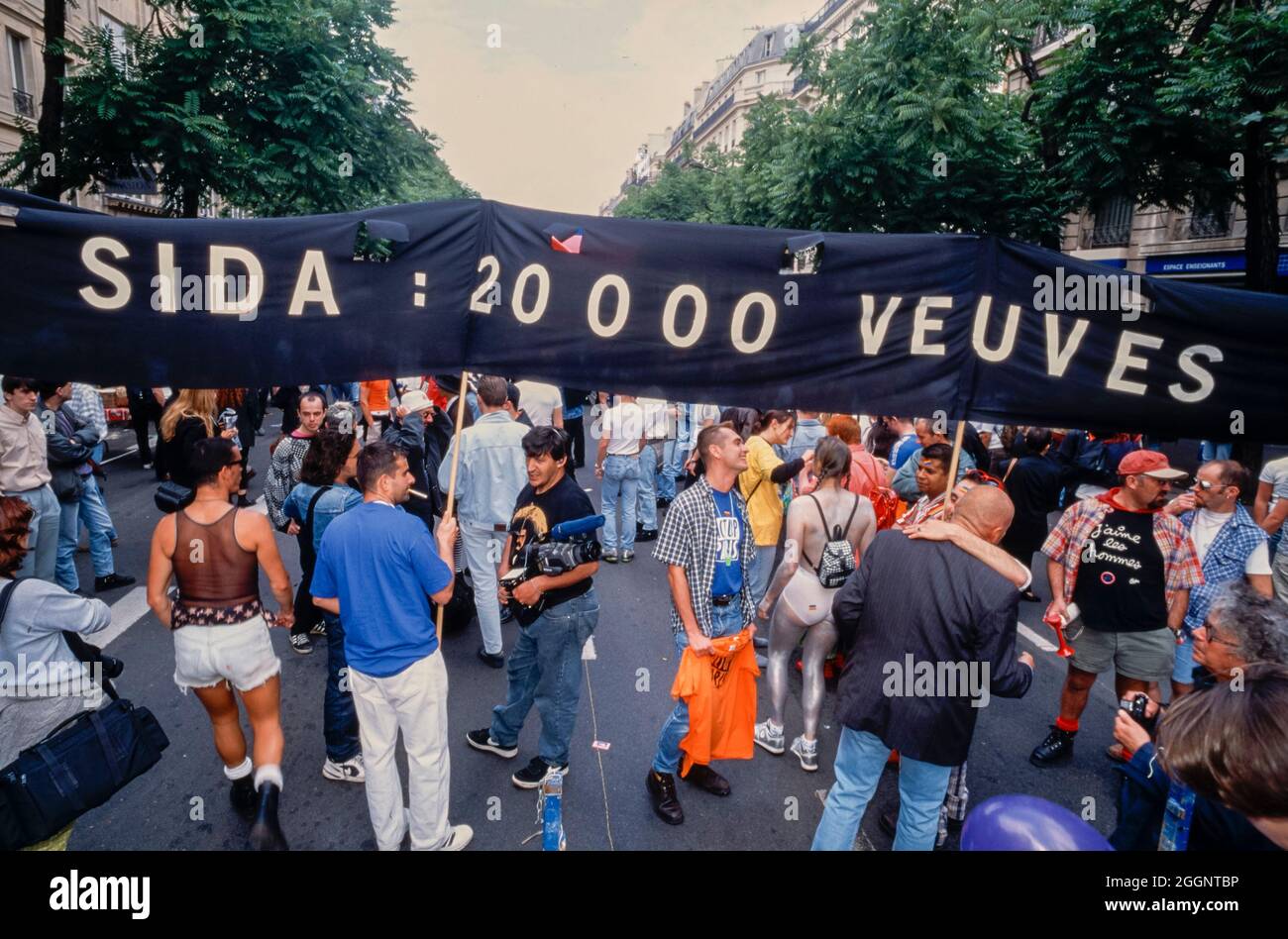 Paris, France, Crowd of People, AIDS Activists of Act Up PAris Demonstrating on Street, 'Gay Pride' 1996 homosexuals young activism, pride march, Protest Banner, 'Aids: 20,000 Widows' Slogan Stock Photo