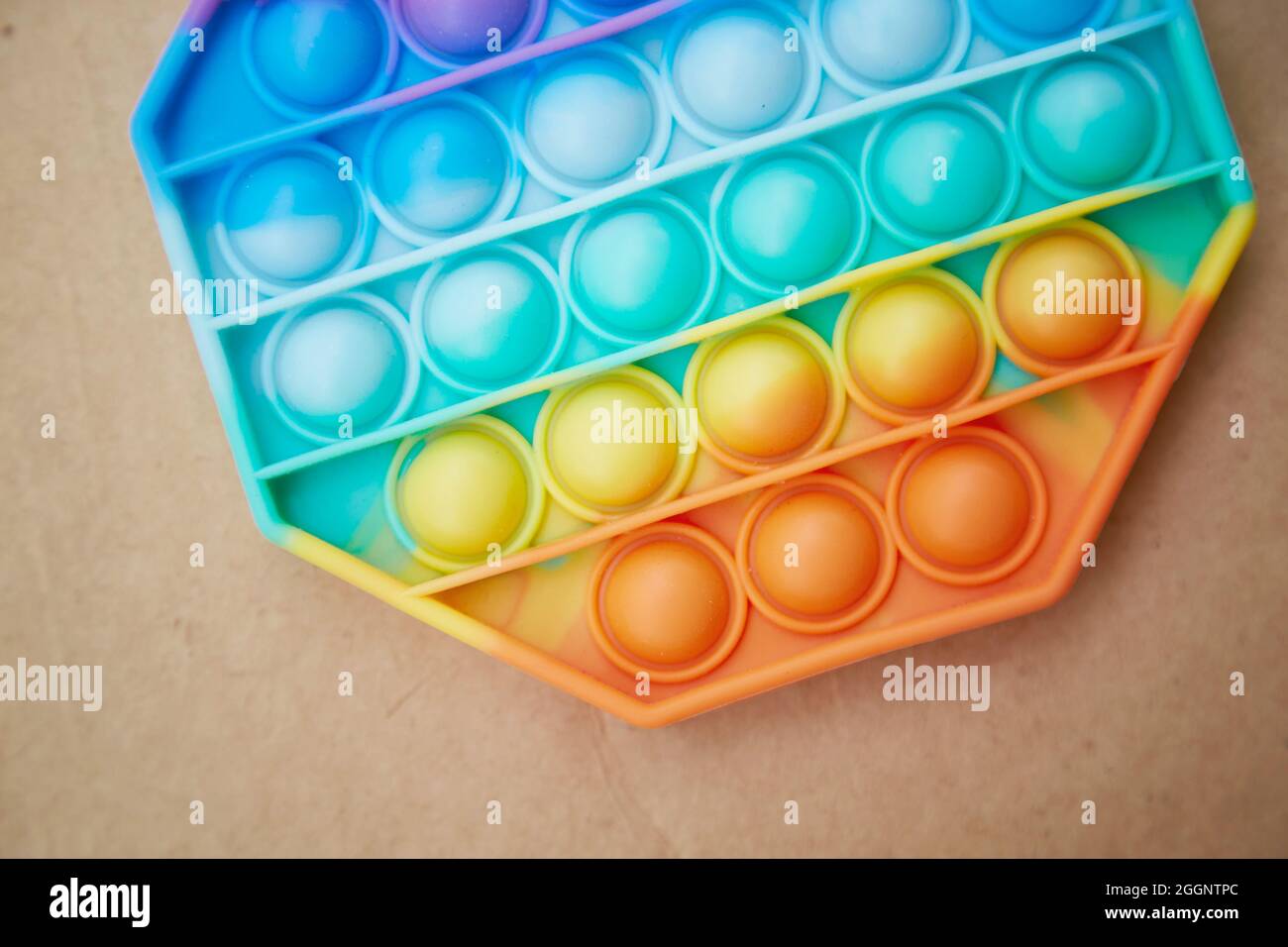 New trendy silicone toy close up. Rainbow sensory fidget. Colorful antistress sensory toy fidget pop it toy. Antistress trendy pop it toy. High quality photo Stock Photo