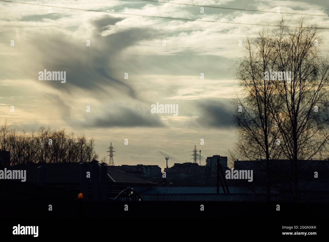 autumn industrial landscape. forest in the period of leaf fall and abandoned industrial buildings. power lines in the suburbs. workshops of the old fa Stock Photo