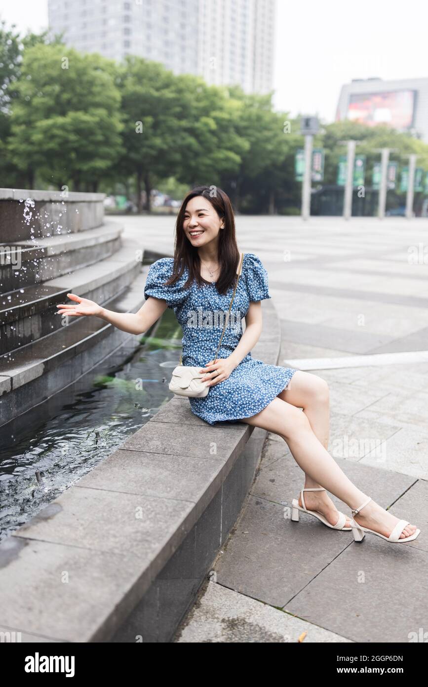 Portrait of young asian woman wearing stylish summer dress and walking outdoor in city. Happy stylish woman with smiley face enjoys life Stock Photo - Alamy Portrait of young asian woman wearing stylish summer dress and walking outdoor in city. Happy stylish woman with smiley face enjoys life Stock Photo - Alamy
