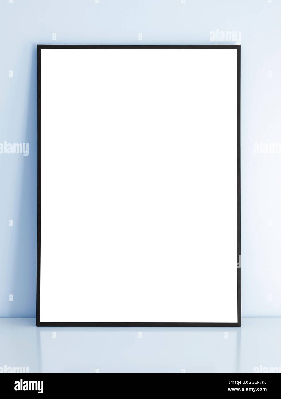 Thin black mock up frame on table with blue wall. Stock Photo