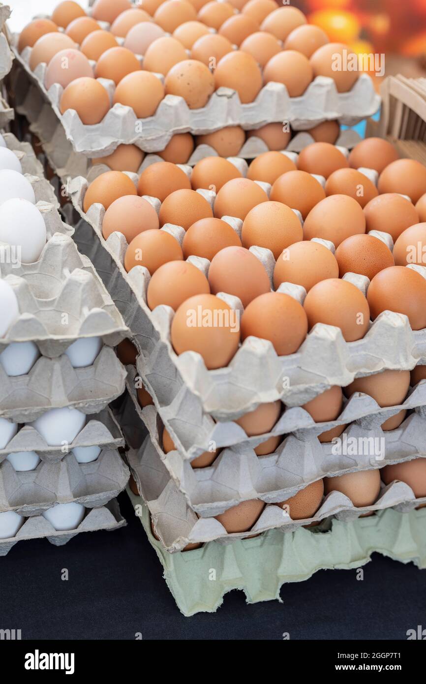 Boxes of fresh farmers eggs stacked o top of each other. Stock Photo