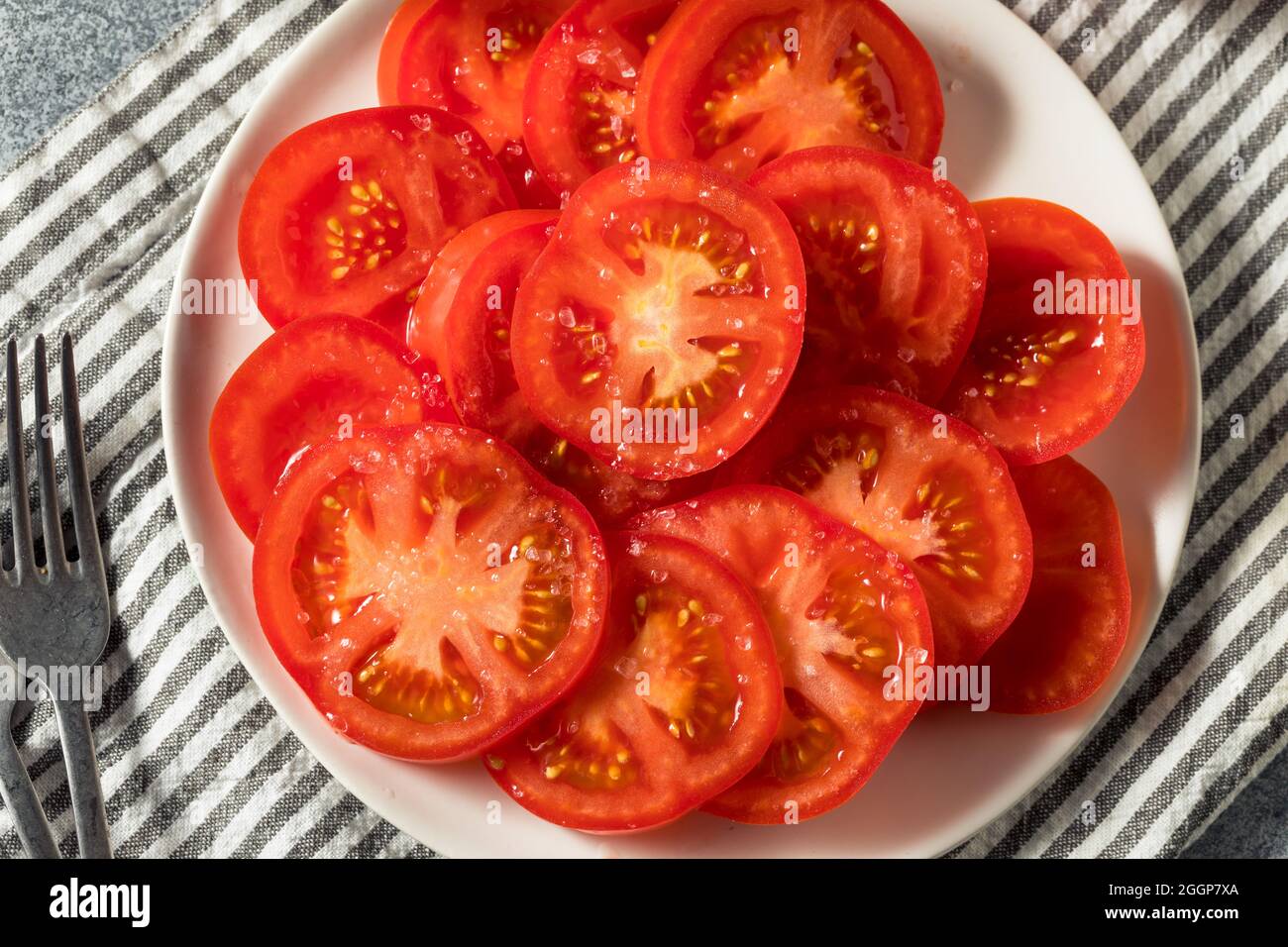 Healthy Organic Sliced Tomatoes with Salt Ready to Eat Stock Photo