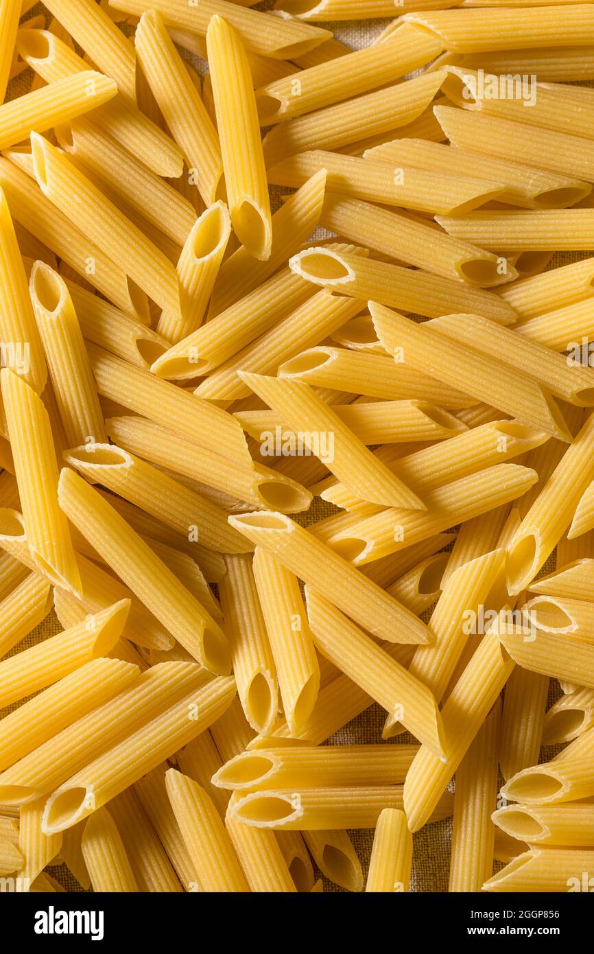 Homemade Raw Dry Penne Pasta in a Bowl Stock Photo Alamy