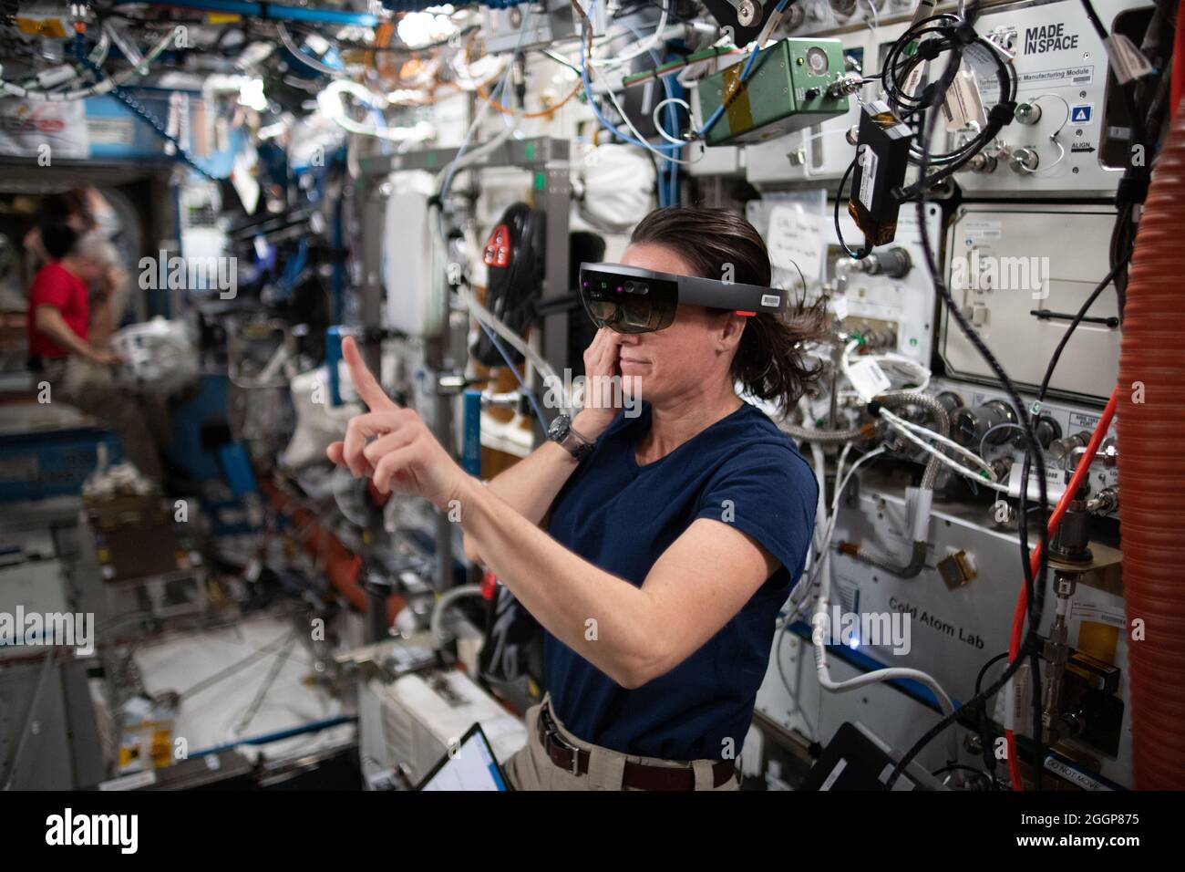 NASA astronaut and Expedition 65 Flight Engineer Megan McArthur wears a specialized Sidekick headset and tests using augmented reality aboard the International Space Station, June 30, 2021. Stock Photo