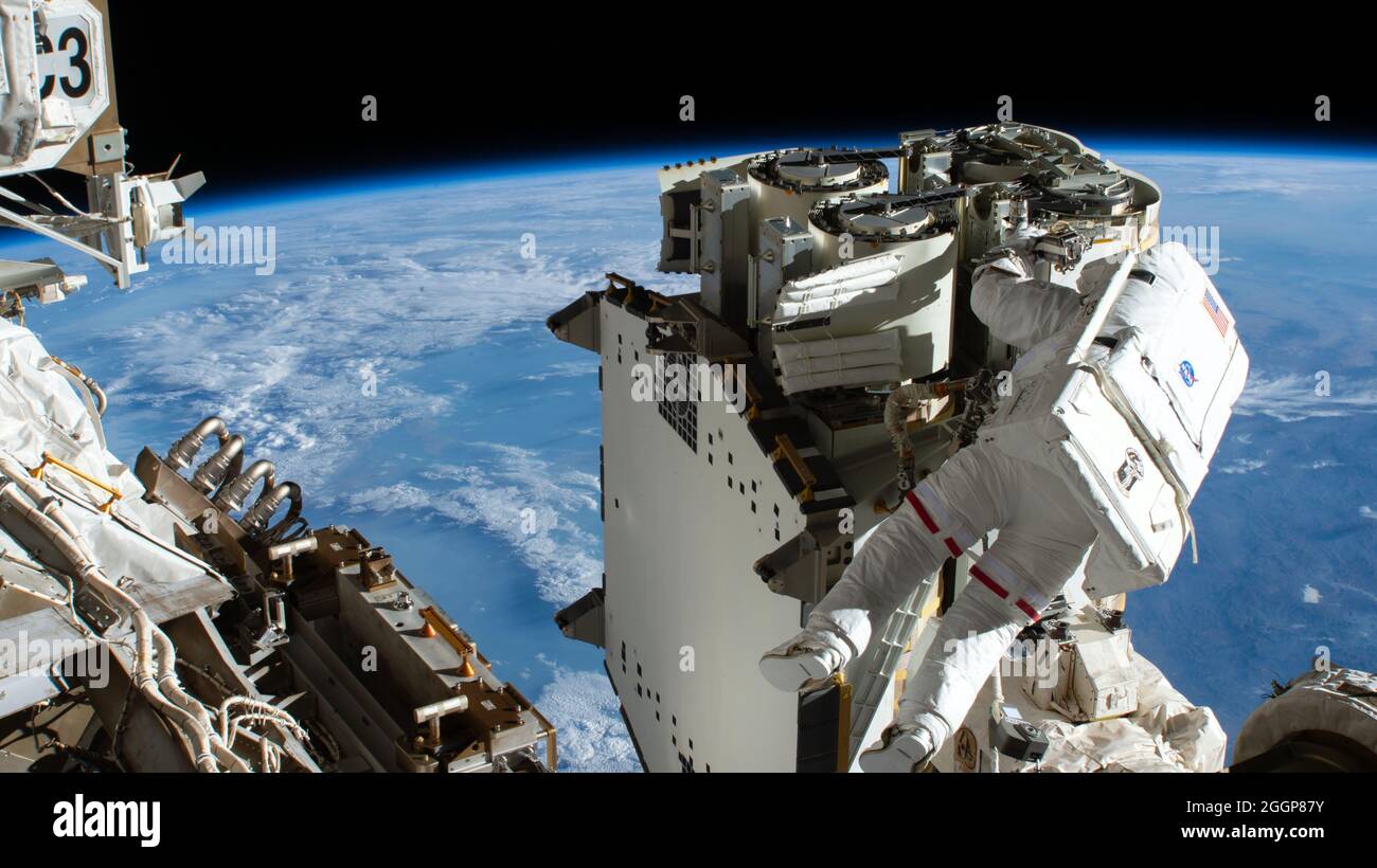 Expedition 65 Flight Engineer Thomas Pesquet of ESA (European Space Agency) works to remove new roll out solar arrays from flight support equipment to begin installation work on the International Space Station's truss structure, June 16, 2021. Stock Photo