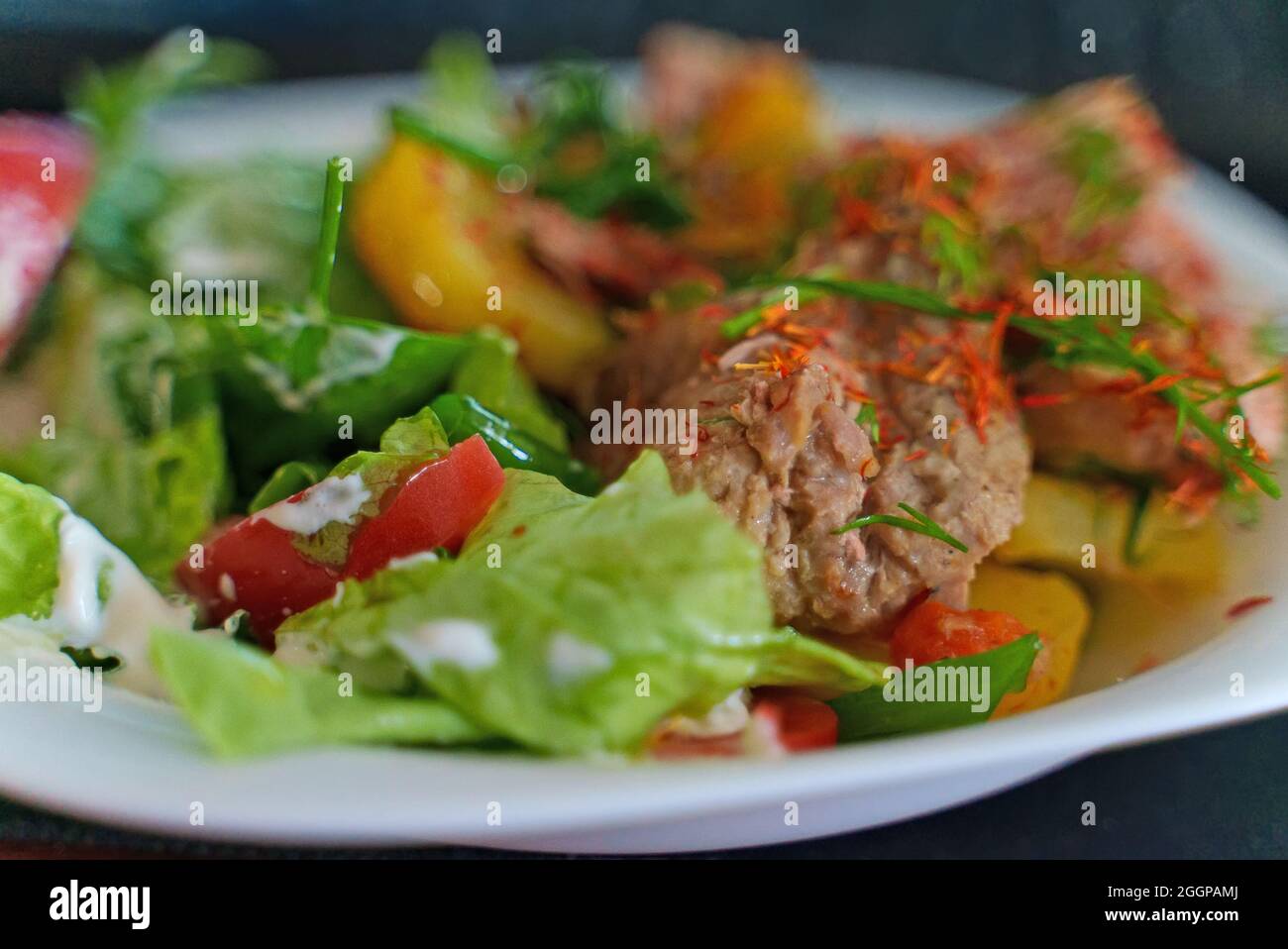 Pulled pork with potatoes and herbs. Stock Photo