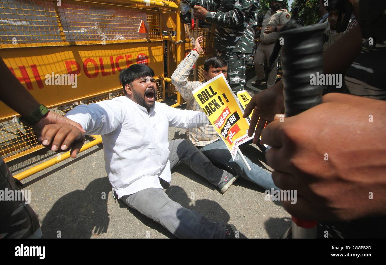 Activists of Indian Youth Congress being detain by security personnel while shouting slogans against Prime Minister Narendra Modi government policy against rising inflation, price hike of Liquefied Petroleum (LPG) gas cylinder, Petrol, Diesel in the country, during a protest in New Delhi. Stock Photo