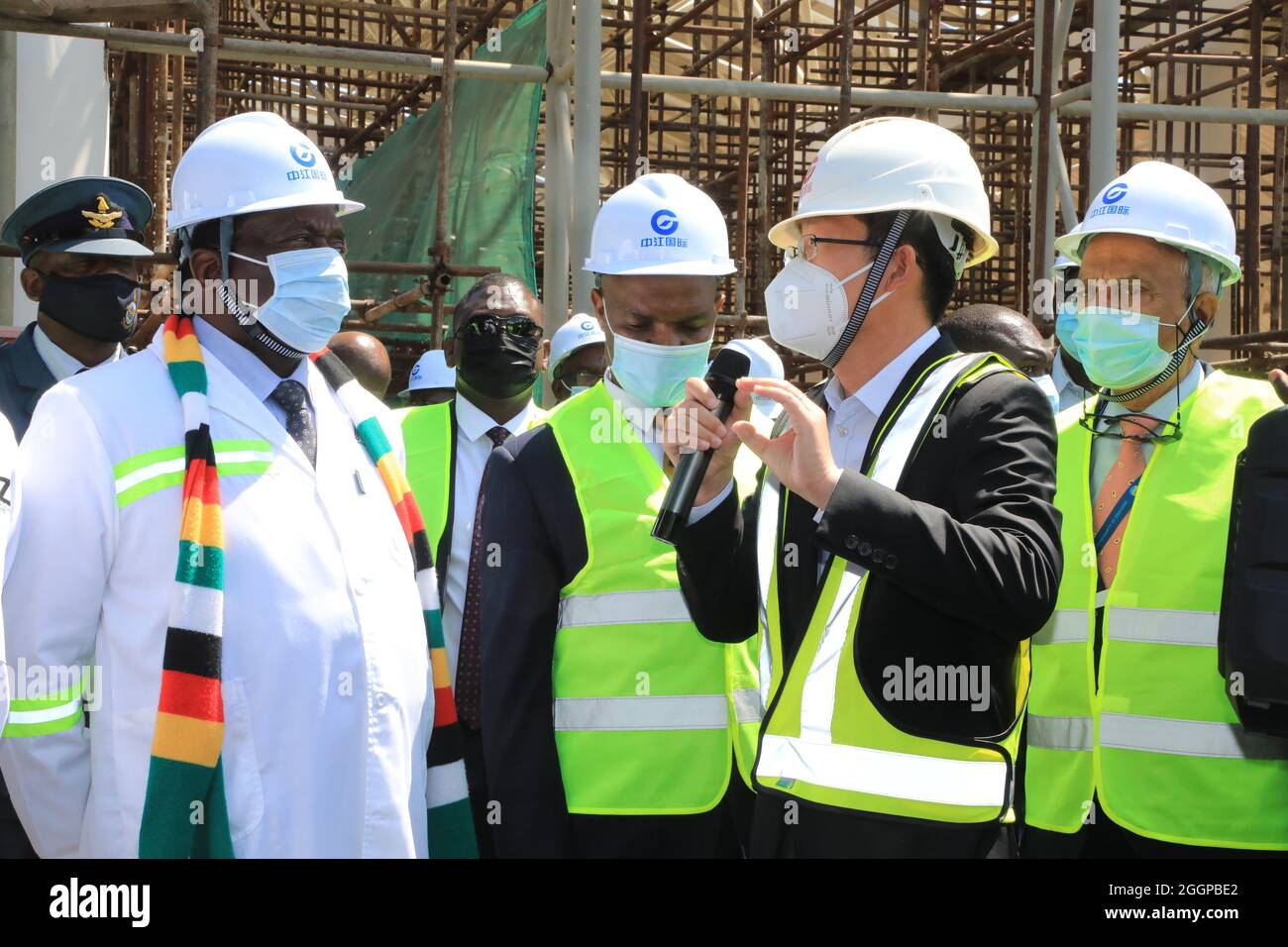 (210902) -- HARARE, Sept. 2, 2021 (Xinhua) -- Zimbabwean President Emmerson Mnangagwa (1st L, front) talks to project manager Wei Wei (2nd R) at the construction site of the expansion project of Robert Gabriel Mugabe International Airport in Harare, Zimbabwe, Sept. 1, 2021.  The completion of Robert Gabriel Mugabe International Airport expansion will significantly increase tourist arrivals, Zimbabwean President Emmerson Mnangagwa said Wednesday.   The project, undertaken by China Jiangsu International, a Chinese contractor, is underway despite delays caused by the COVID-19 pandemic. (Photo by Stock Photo