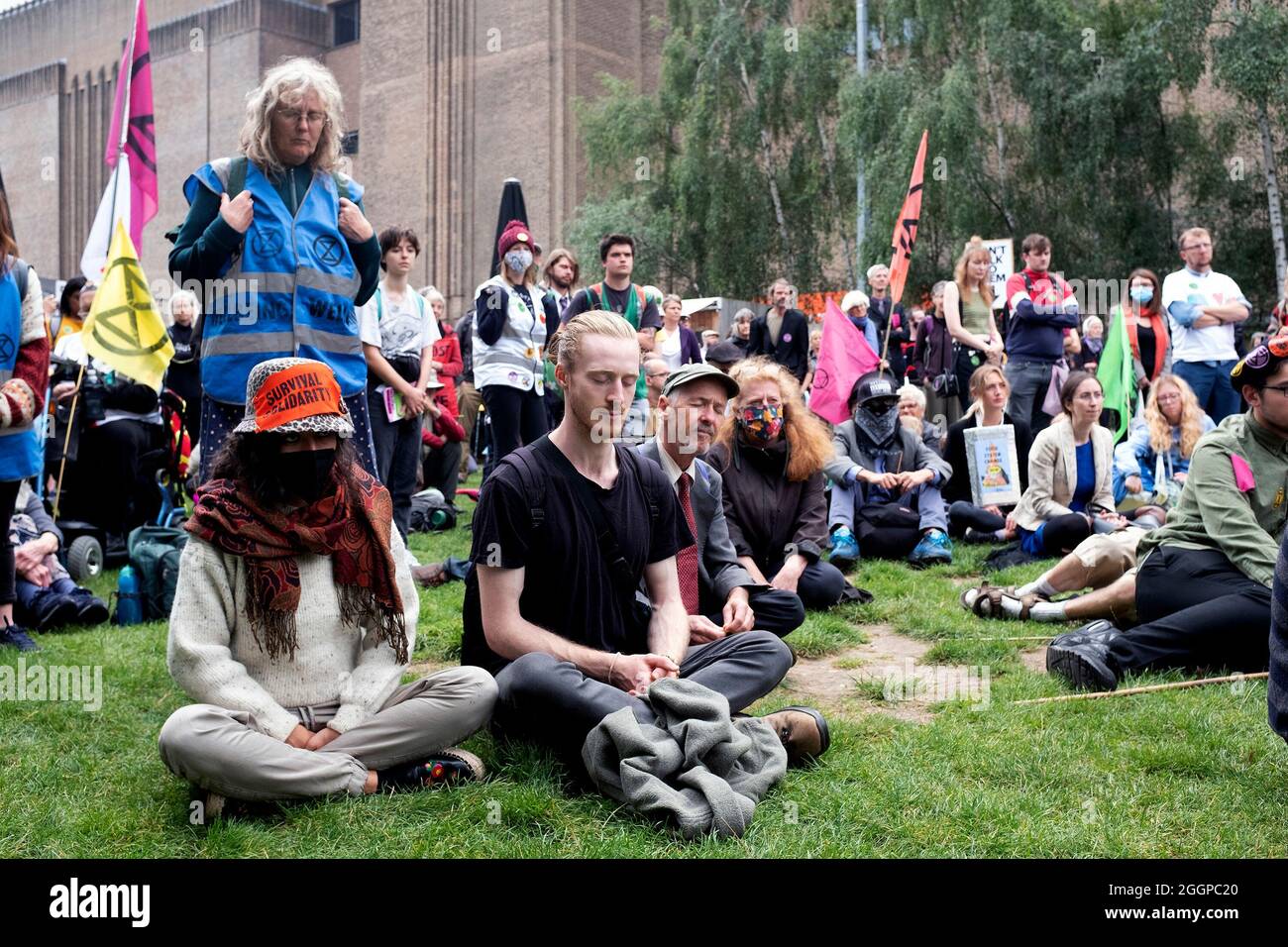 Protestors take a moment to breath during a speech as protestors gather outside of Tate Modern ahead of Extinction Rebellion's Mass Bail Break protest on the eleventh day of their Impossible Rebellion protests in London, United Kingdom on September 2, 2021. Stock Photo