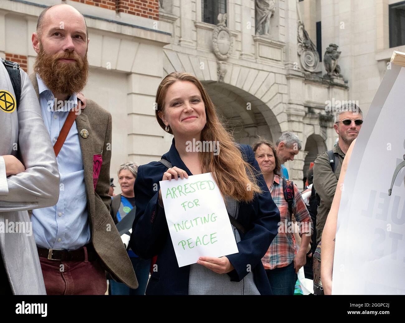 Protestor holds a placard saying 'ARRESTED FOR INCITING PEACE' as protestors continue march from Tate Modern during Extinction Rebellion's Mass Bail Break protest on the eleventh day of their Impossible Rebellion protests in London, United Kingdom on September 2, 2021. Stock Photo