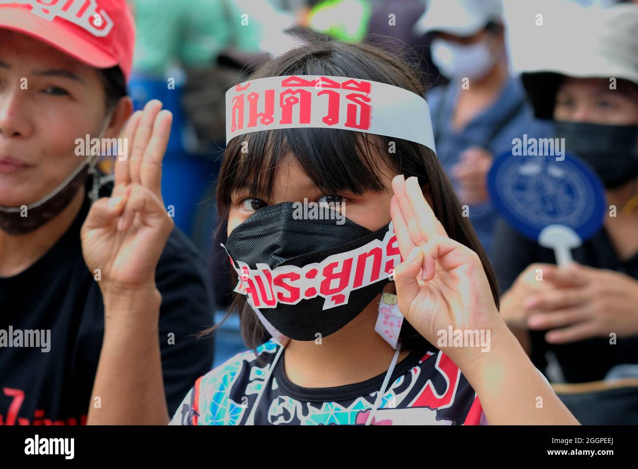 Bangkok, Thailand, 2 September 2021, a girl gives the three finger salute as part of a protest demanding the resignation of Prime Minister General Prayut Chan-ocha. The protests are part of an ongoing series across Bangkok to voice disaffection with the current government's performance during the COVID pandemic. Credit: James Patrick/Alamy Live News Stock Photo