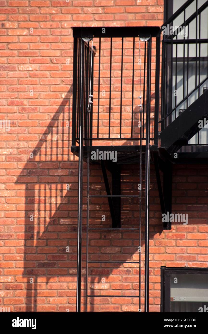 Steel fire escapes on the exterior of a brick apartment building in Hoboken, New Jersey, USA. Stock Photo