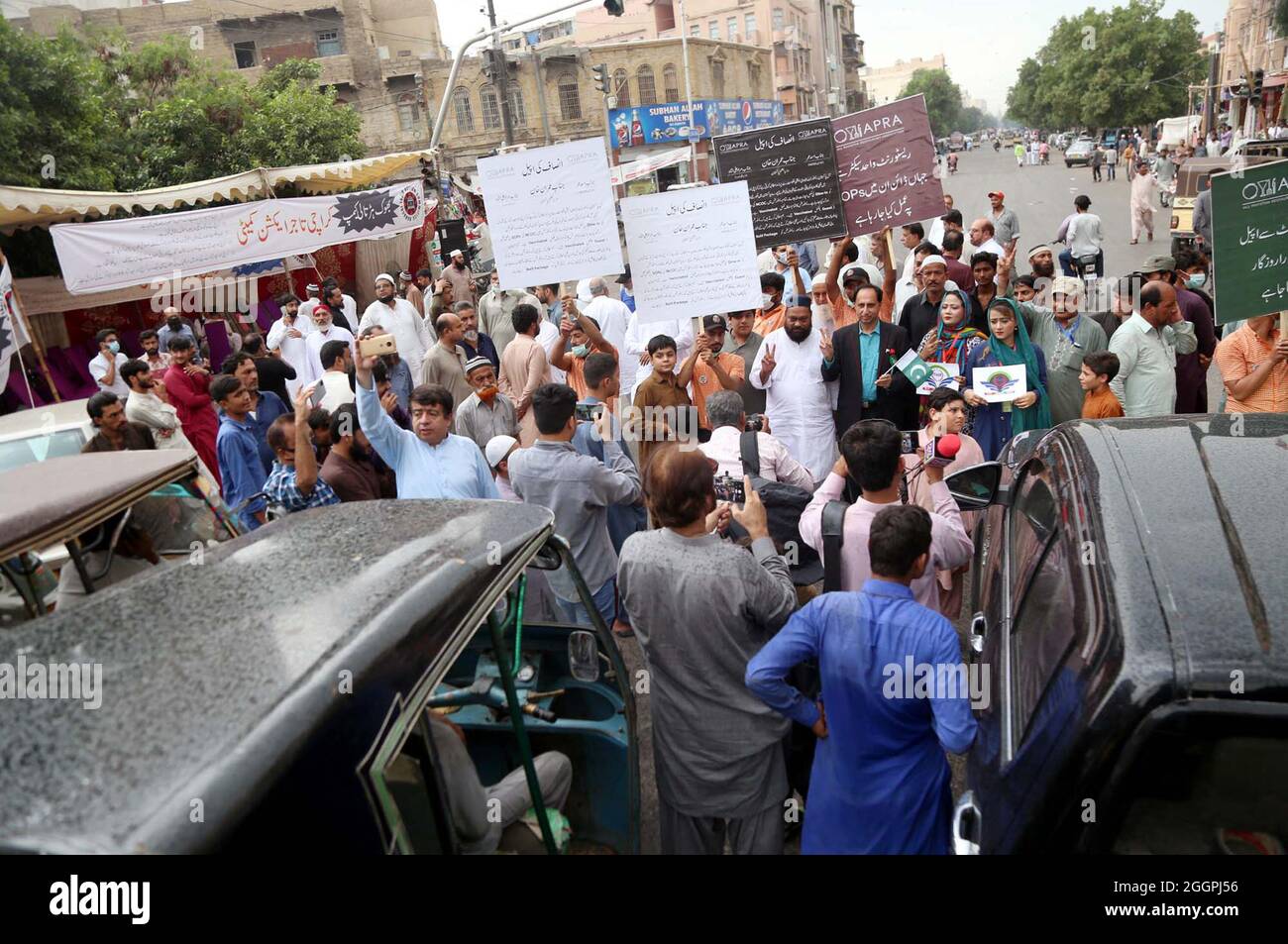 Members of Karachi Tajir Action Committee block M.A Jinnah road as they are holding protest demonstration against unemployment, hunger due to shortage of foods in their homes and re-imposed smart lockdown by government while demanding allow to run their business activities normally, near Light House Market in Karachi on Thursday, September 02, 2021. Stock Photo