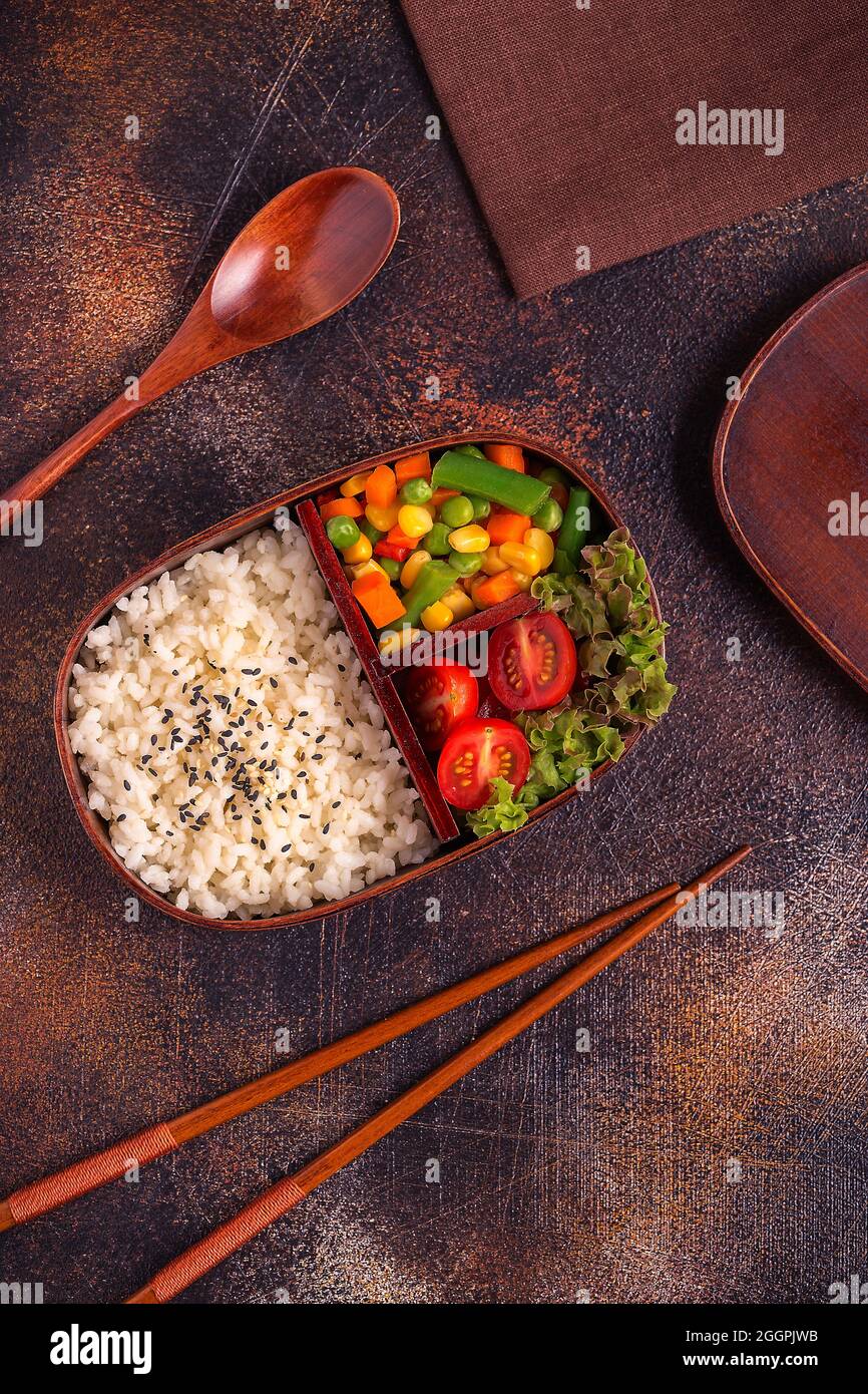 Healthy lunch in wooden japanese bento box. Balanced healthy food