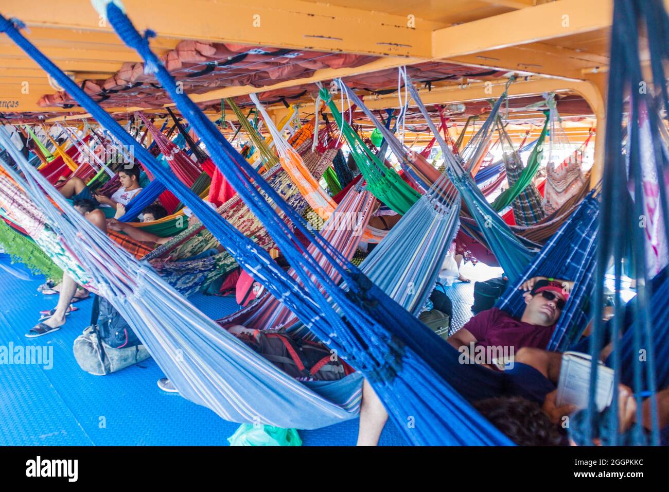 AMAZON, BRAZIL - JUNE 27, 2015: Passengers of hammock deck at the boat Anna Karoline II which plies river Amazon between Santarem and Manaus, Brazil. Stock Photo