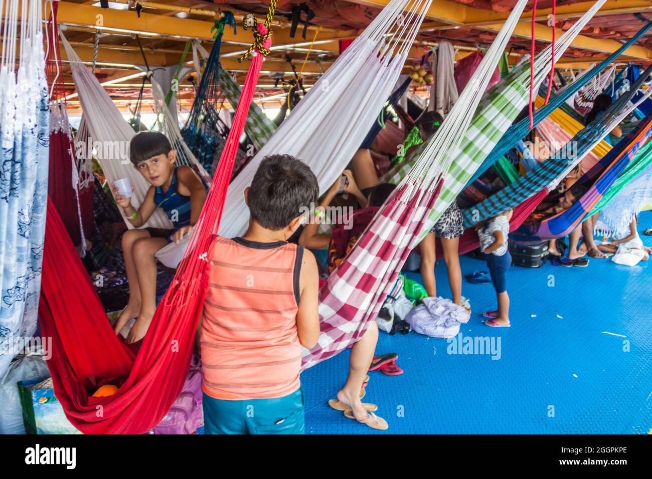 AMAZON, BRAZIL - JUNE 27, 2015: Passengers of hammock deck at the boat Anna Karoline II which plies river Amazon between Santarem and Manaus, Brazil. Stock Photo
