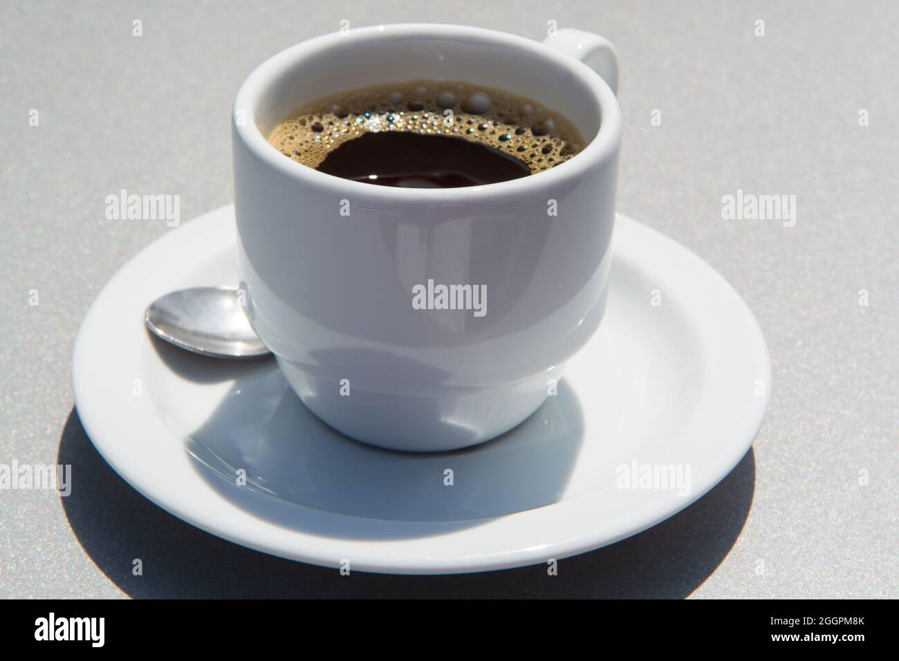 White cup of black coffie on gray background close up Stock Photo