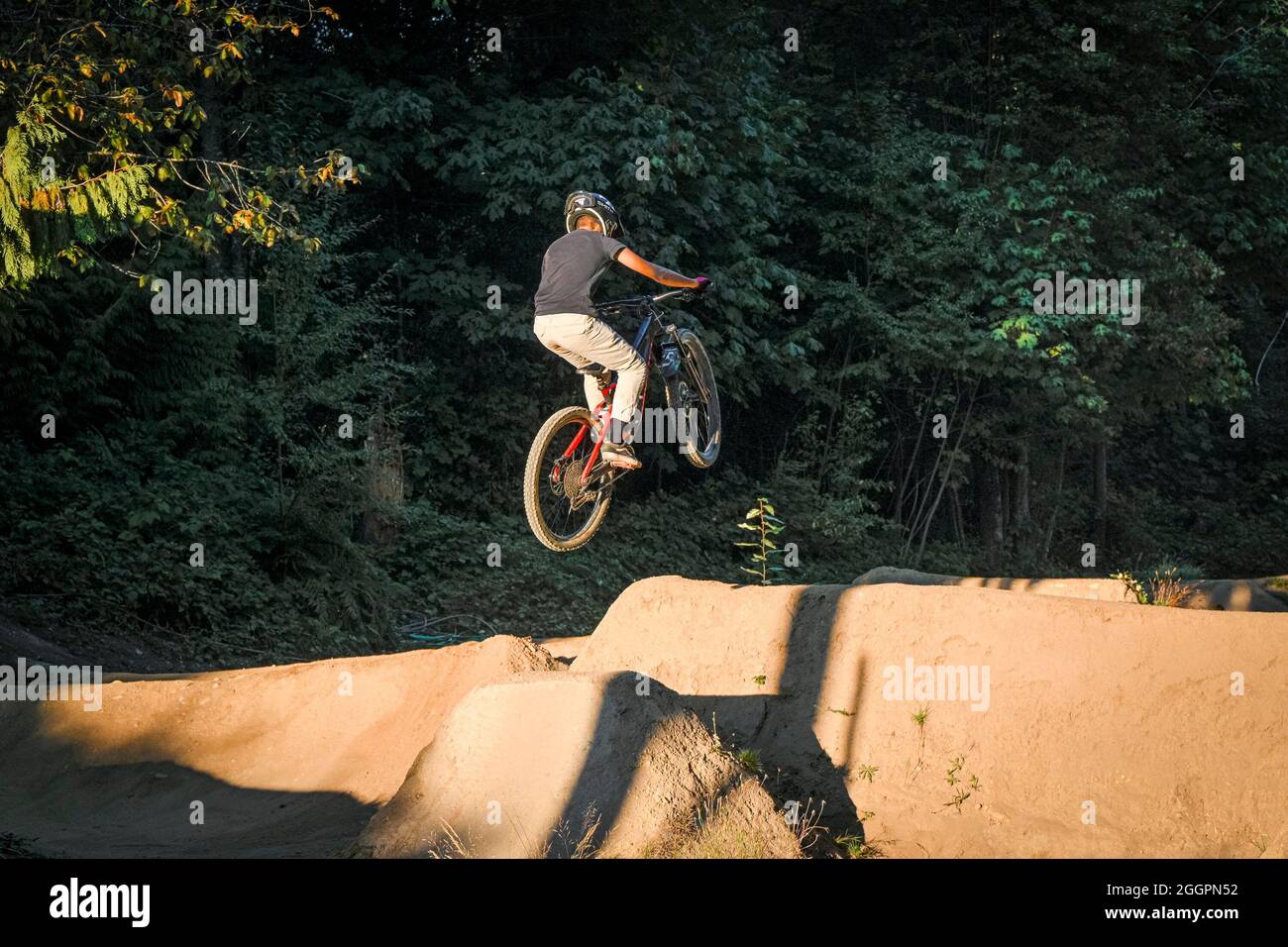 BMX Bike jumping, Loutet Dirt Jumps  skillpark, North Vancouver, British Columbia, Canada Stock Photo
