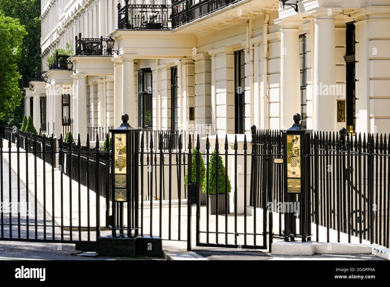 London, England - August 2021: Pedestrian gate with secure access buttons outside a terrace of townhouses overlooking Hyde Park Stock Photo