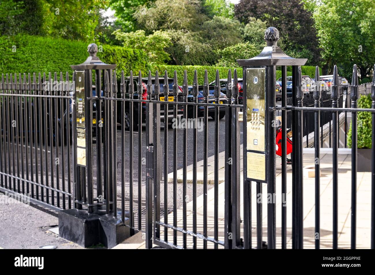 London, England - August 2021: Pedestrian gate with push button security access to a street of town houses near Hyde Park. Stock Photo