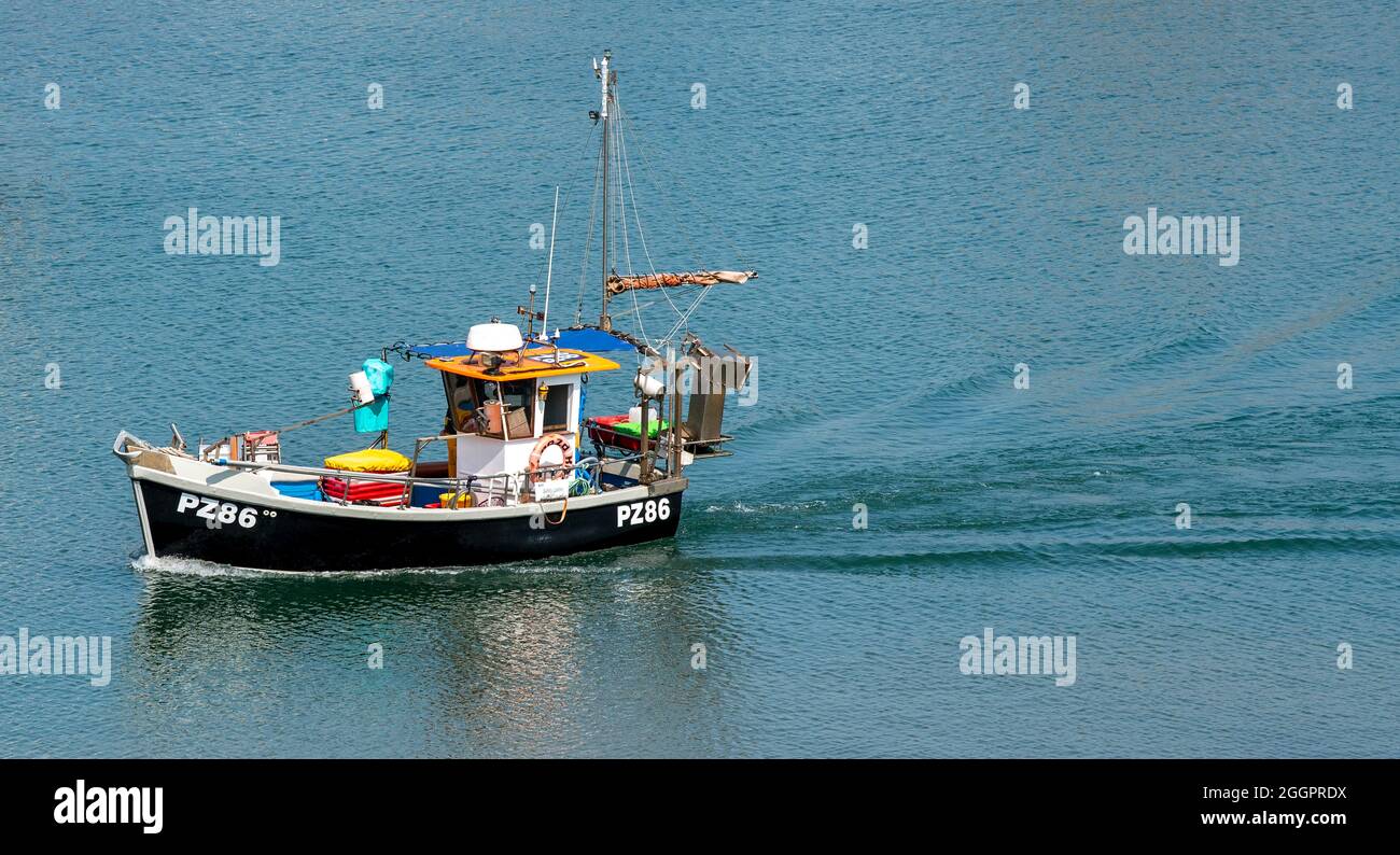 Newlyn, Cornwall, England, UK. 2021. A small fishing boat sailing into