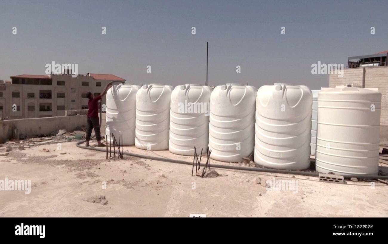 Biprodukt Bekræfte eksplodere A screen grab shows a boy as he fills tanks with water, in Amman, Jordan  September 1, 2021. Video taken September 1, 2021. REUTERS TV/via REUTERS  Stock Photo - Alamy