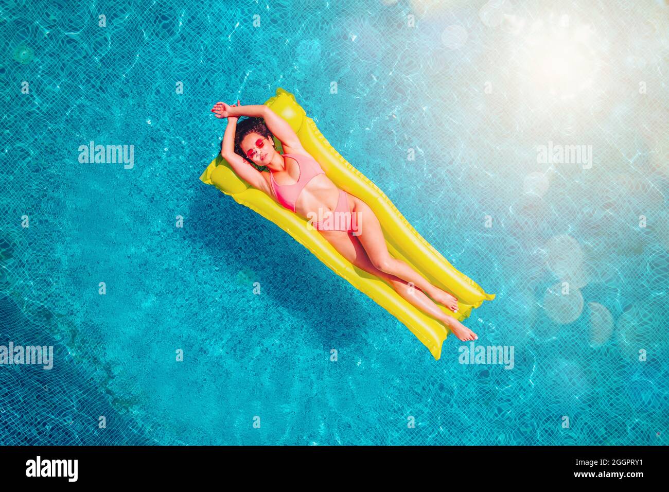Girl in swimsuit who tan in a swimming pool Stock Photo