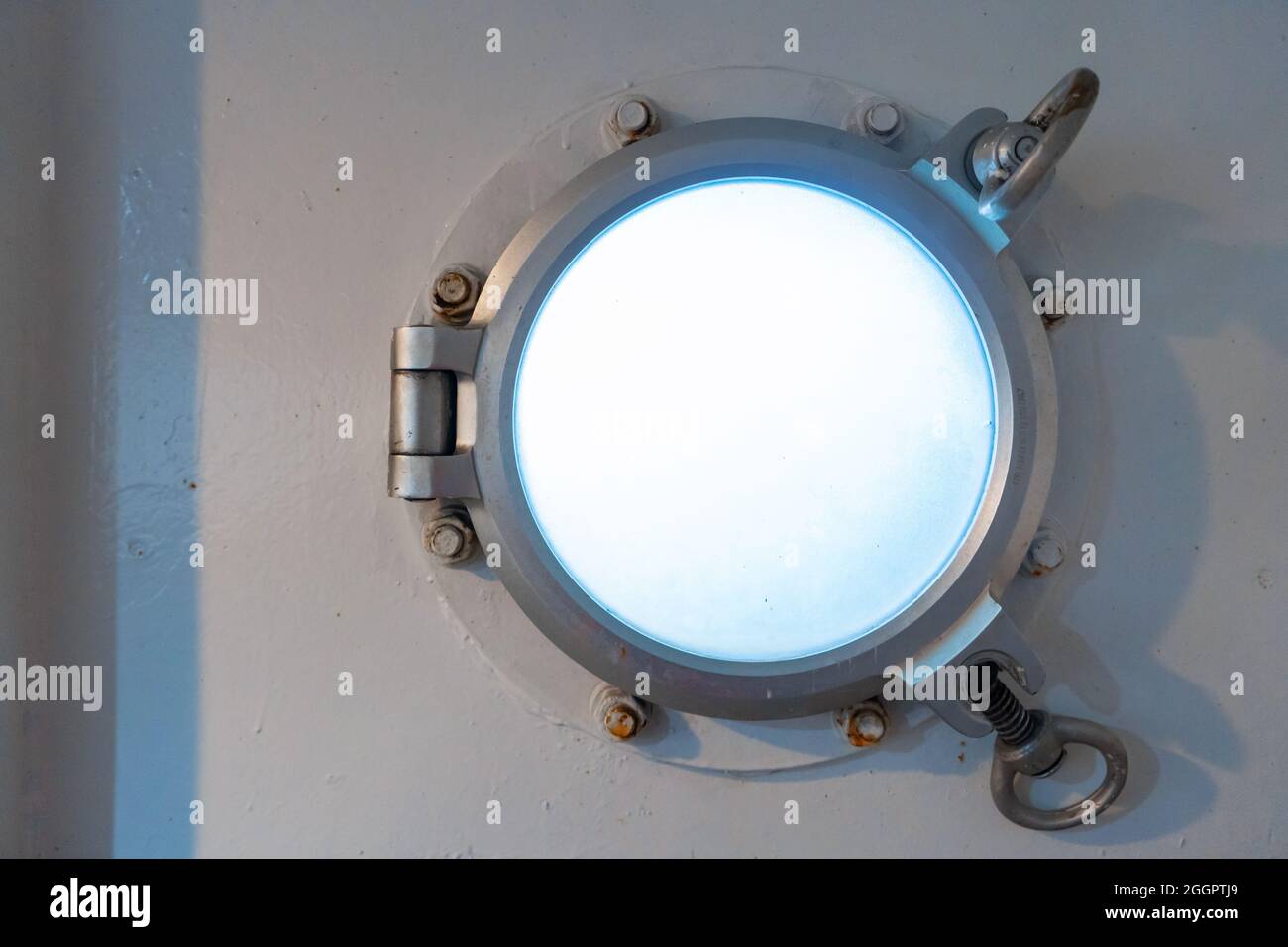 Porthole in the ferry cabin. The ferry sails on the sea Stock Photo Alamy