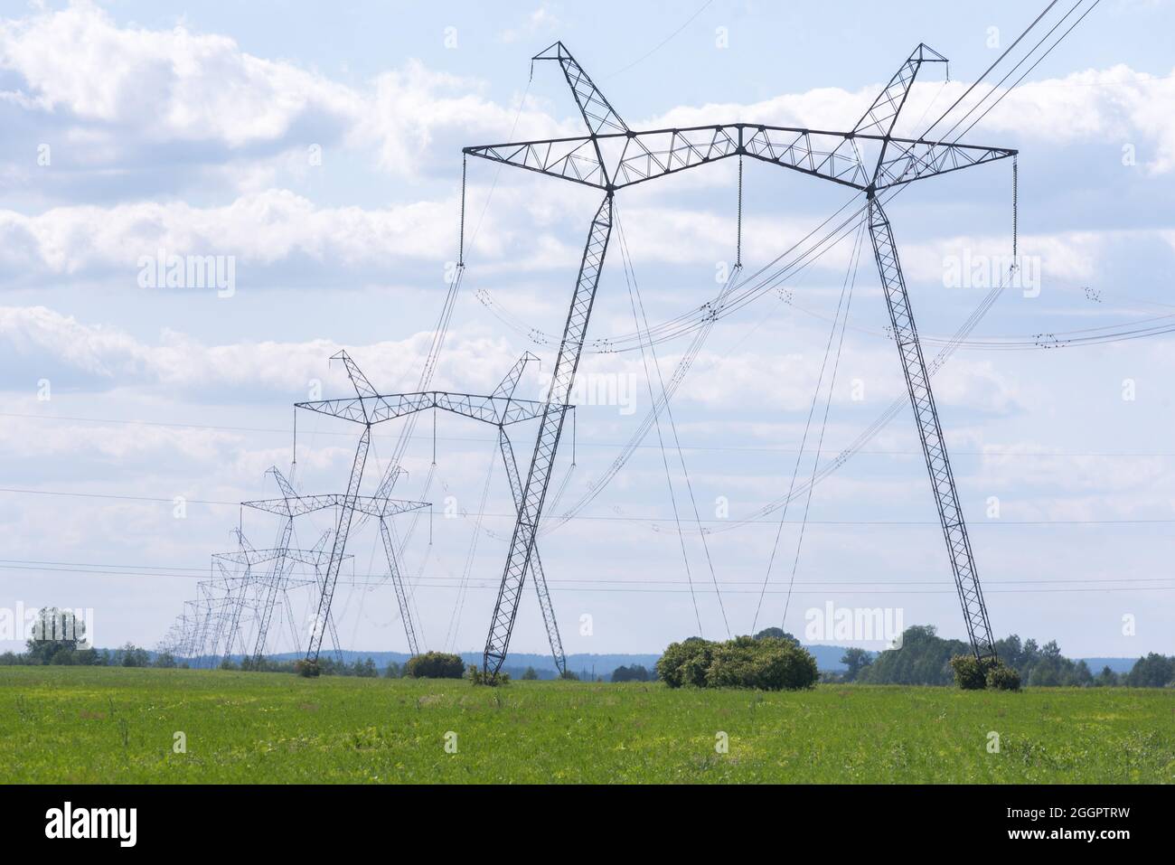 A view of power lines, electric power transmissions in a field in western Ukraine.Prime Minister of Ukraine, Denis Shmygal announced that from October 1st, the cost of electricity for 80% of the population will decrease following the Cabinet of Ministers passing a resolution which reduced the electricity tariff to UAH 1.44 per kilowatt/hour if households consume less than 250 kilowatt/hours per month. At the same time, if the household uses more than this norm, then all consumed electricity must be paid at full price - UAH 1.68 per kWh. Stock Photo