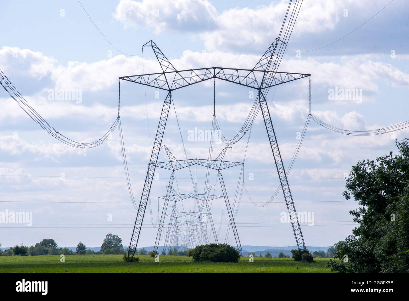 A view of power lines, electric power transmissions in a field in western Ukraine.Prime Minister of Ukraine, Denis Shmygal announced that from October 1st, the cost of electricity for 80% of the population will decrease following the Cabinet of Ministers passing a resolution which reduced the electricity tariff to UAH 1.44 per kilowatt/hour if households consume less than 250 kilowatt/hours per month. At the same time, if the household uses more than this norm, then all consumed electricity must be paid at full price - UAH 1.68 per kWh. (Photo by Mykola Tys/SOPA Images/Sipa USA) Stock Photo